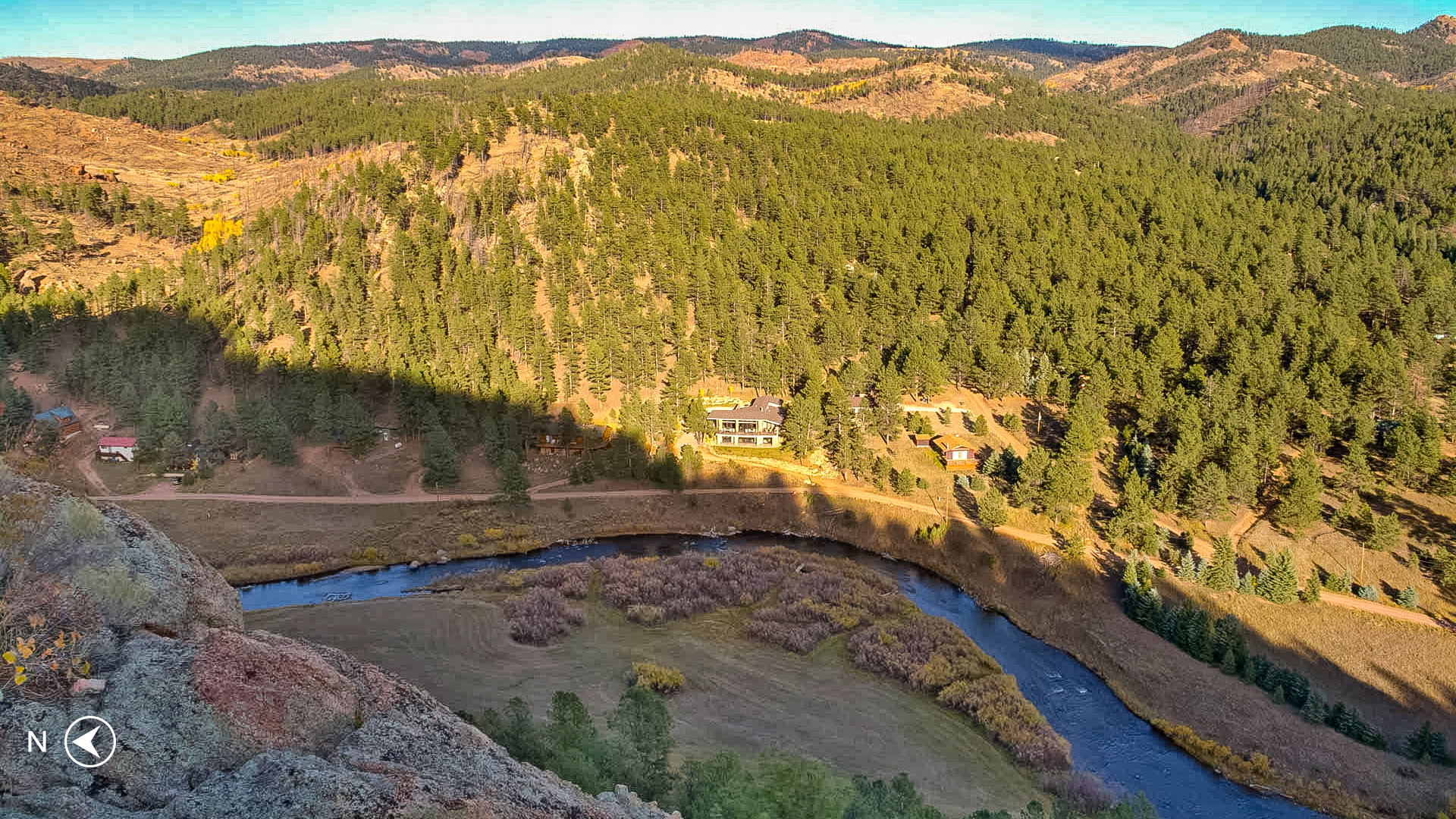 Aerial view of the home at 940 East Platte Road located in the gated community of Sportsmen's Paradise in Lake George, CO. Photo taken from Etch A Sketch Rock across the South Platte River along the trail of the same name.